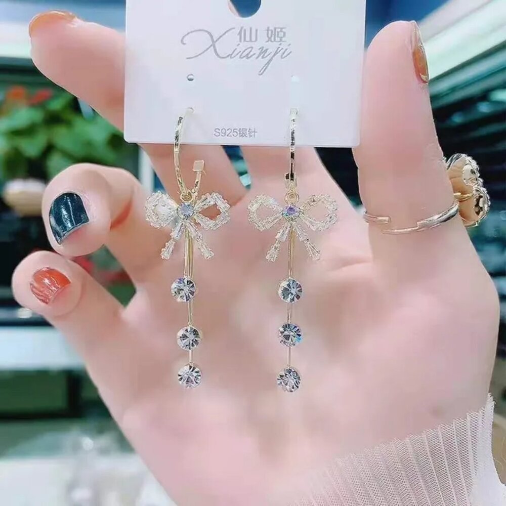 Sparkling Crystal & Tassel Drop Earrings – Gold Ribbon Bow